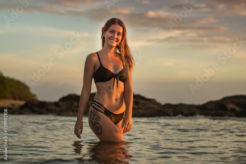 Smiling bikini girl in water