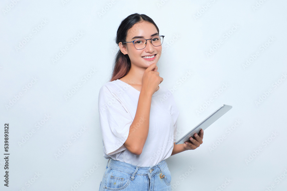 Portrait of smiling young Asian girl in white t-shirt using digital tablet isolated on white background Portrait of smiling young Asian girl in white t-shirt using digital tablet isolated on white background