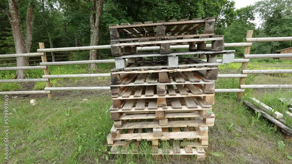A pile of wooden stacks on the ground in the yard of the forest in Estonia A pile of wooden stacks on the ground in the yard of the forest in Estonia