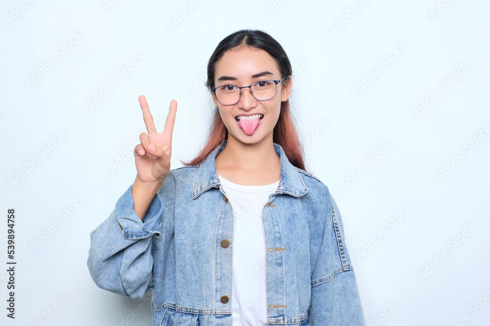 Cheerful young pretty woman showing peace gesture isolated on white background Cheerful young pretty woman showing peace gesture isolated on white background