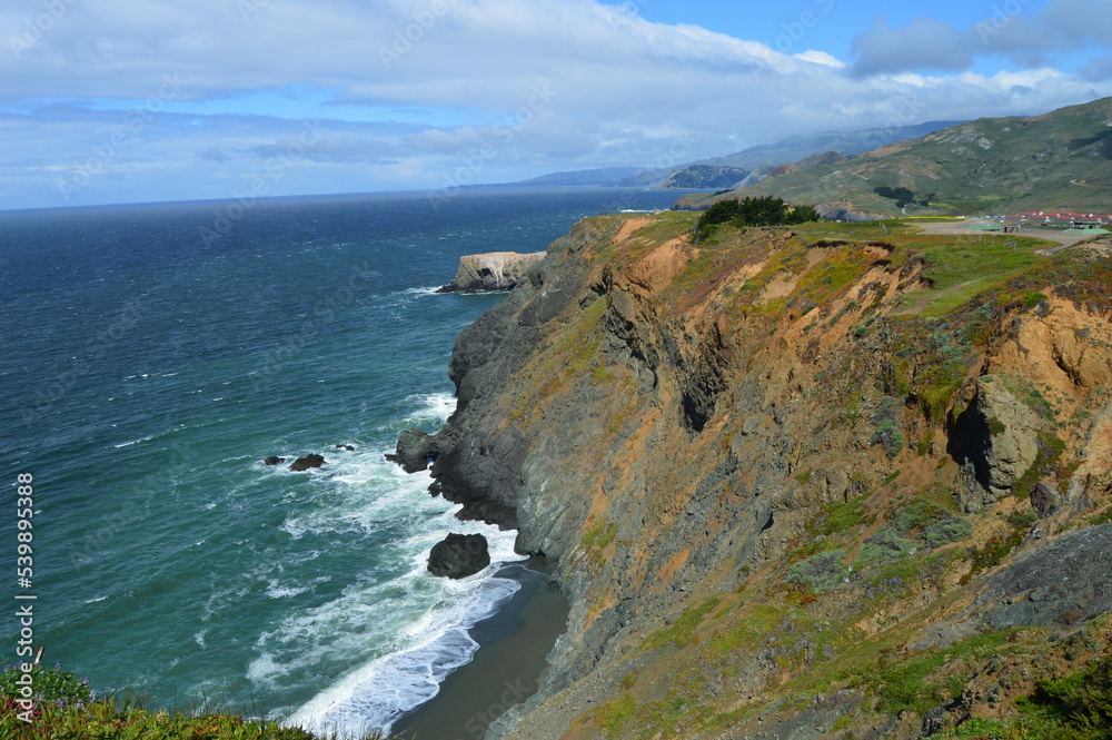 Sea cliffs and black sand beach along Pacific coast north of San Francisco