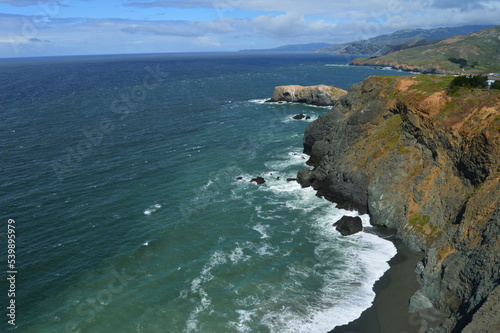 Sea cliffs and black sand beach along Pacific coast north of San Francisco