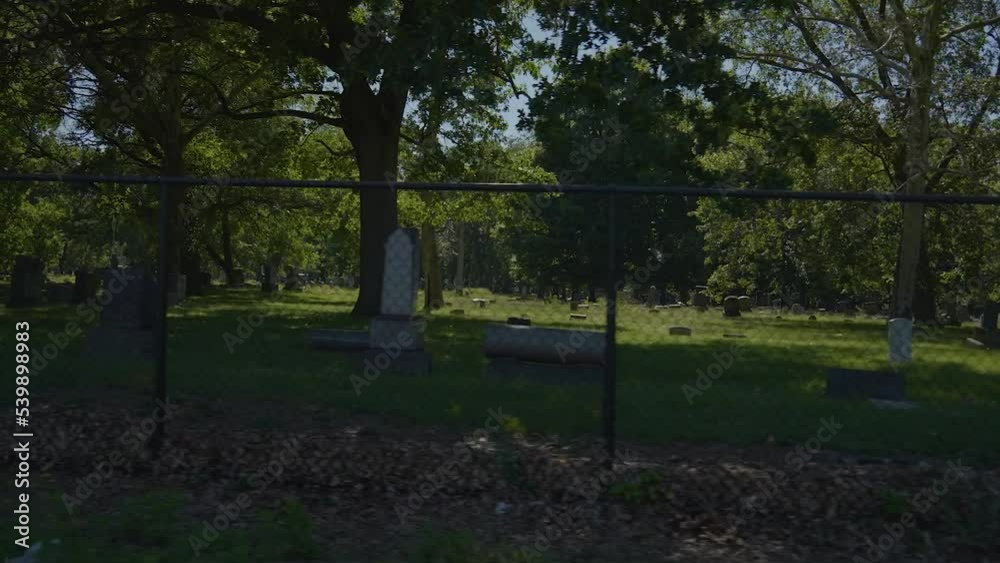 Panning shot of fence with Lake View Cemetery in the background. Panning shot of fence with Lake View Cemetery in the background.