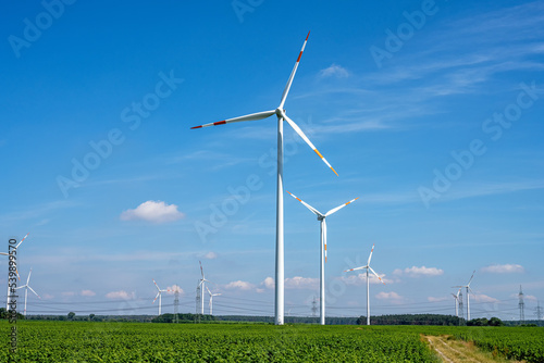 Wind energy plants between agricultural fields seen in Germany