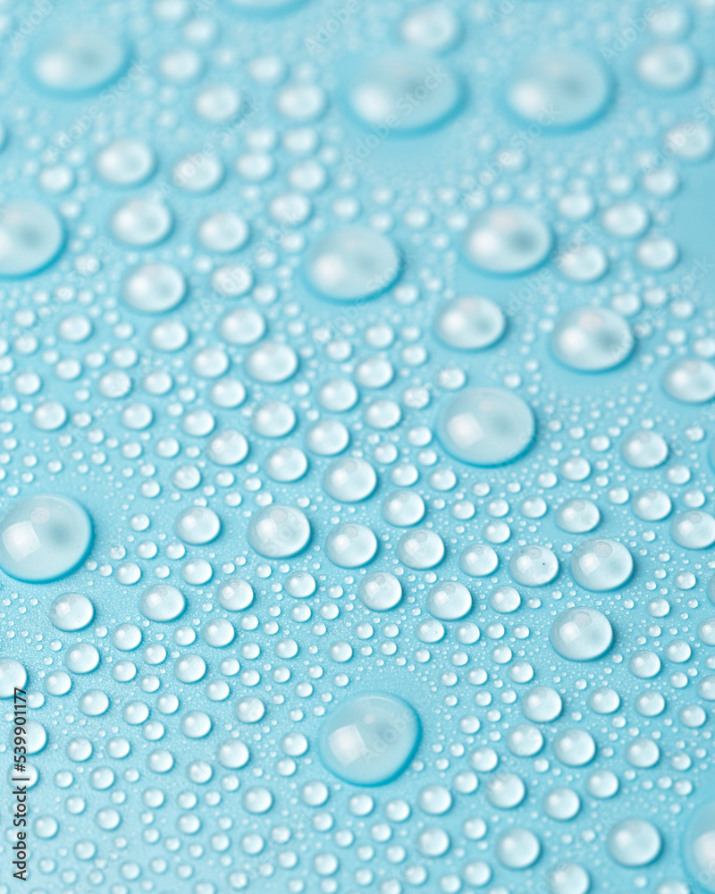 Water drops on a blue background close-up