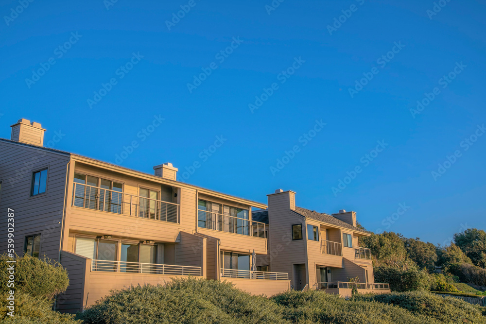 Upscale houses with balconies against blue sky at Del Mar Southern Califronia.