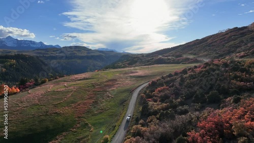 Light glistening off a silver airstream as it barrels down an old country road during Colorado's peak fall season. photo