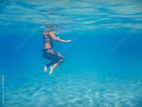 woman hover in clear water on vacation in egypt