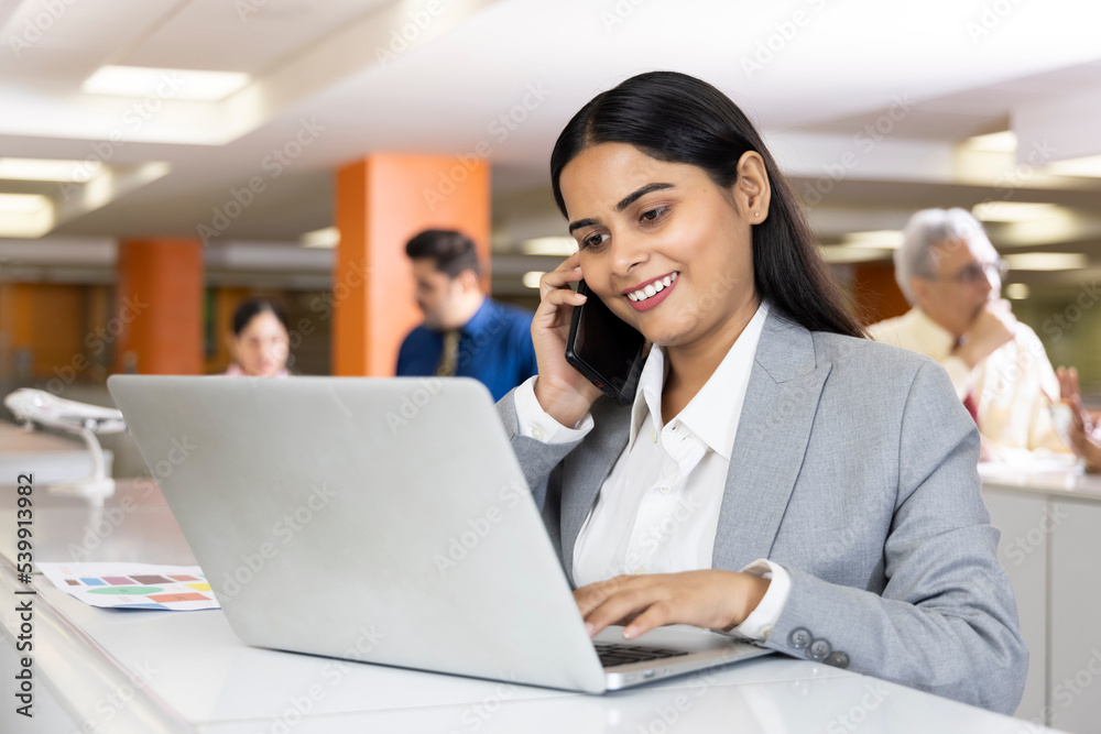 Positive indian businesswoman working on laptop Positive indian businesswoman working on laptop