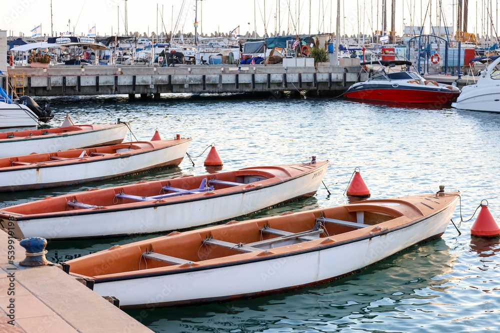 Small yachts near pier on sunny day