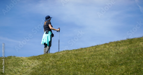 Young sporty hiker woman enyos nature and the view in the italian dolomites. travel and holiday concept.