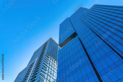 Modern apartments towering against blue sky background on a sunny day