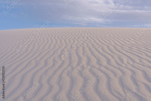 Cloudy blue sky over the ripple white dunes of White Sands National Park  sand dunes and sky