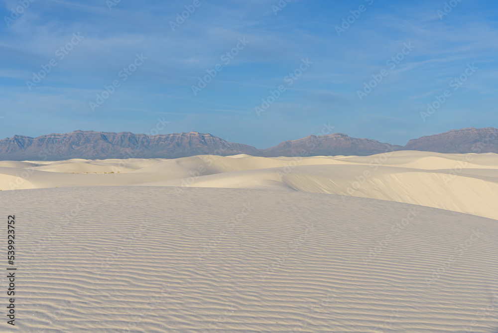 A view of the vast sand dunes at White Sands National Monument, with a clear blue sky, sand dunes in the desert, New Mexico