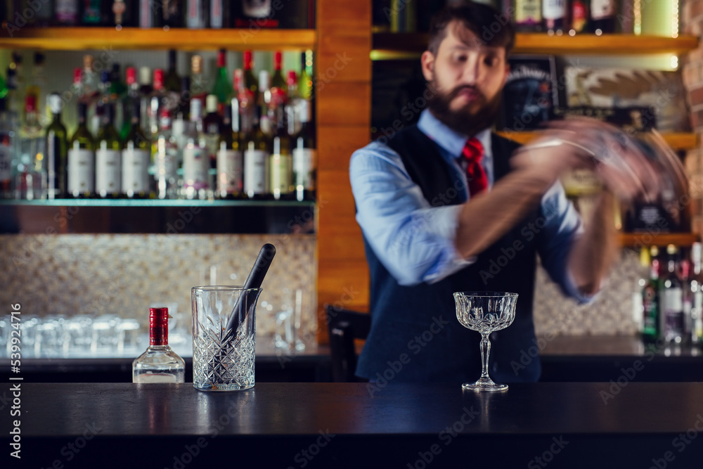 Barman shaking cocktails in bar