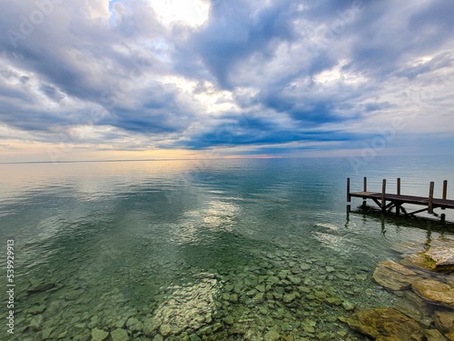 Scenic view of Lake Huron and wooden dock on a cloudy day at Mackinac Island, Michigan