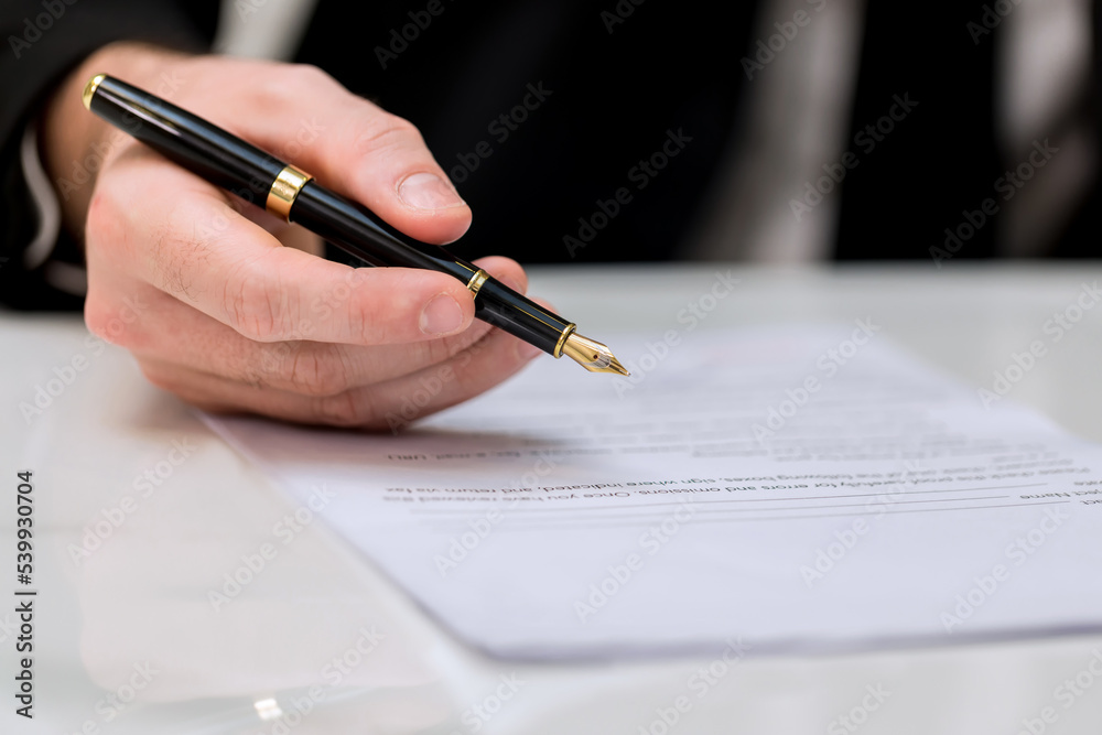 © kanpisut - Business Man approve sign on business document. Business approve sign and certificate concept. Businessman Hands Signing a document