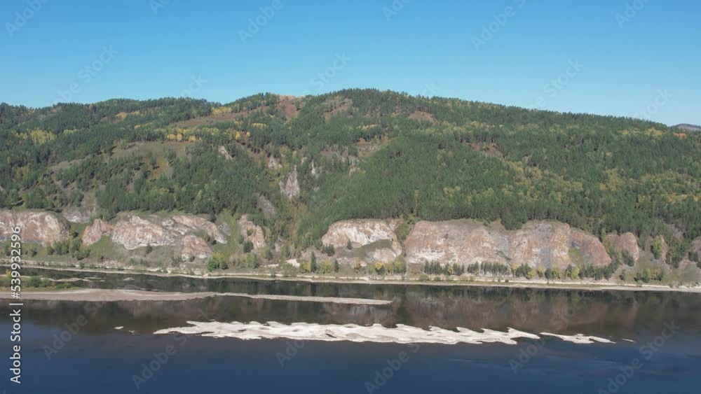 Beautiful landscape flight over the river bank with rocks, aerial shot