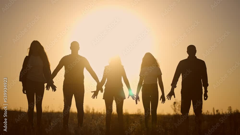 teamwork. team community a holding hands together silhouette at unity sunset. group of people hands. teamwork of workers. team in the company running lifestyle partnership business community hand