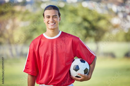 Soccer, sports and fitness with a man athlete holding a ball on a field or grass pitch for training. Football, workout and exercise with a male player outdoor for health, wellness or practice