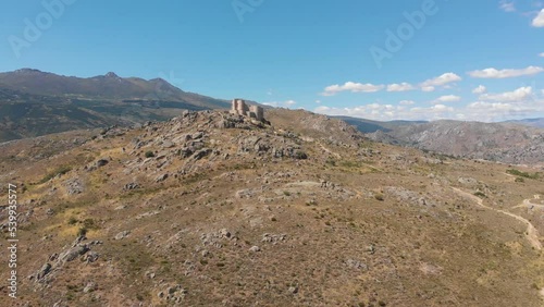 Vista de dron del castillo de Aunqueospese, con la sierra de Gredos al fondo, en la provincia de Ávila, España photo