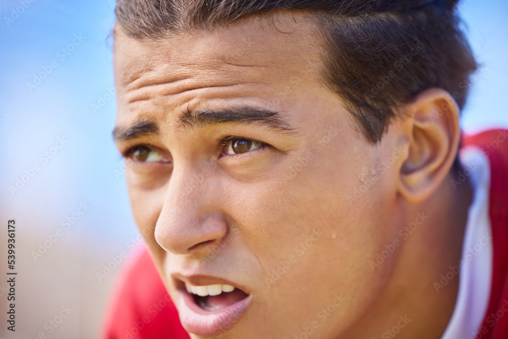 Fototapeta premium Soccer player, tired and sweat on face after sports training, game or match feeling exhausted and breathing heavy outdoor after workout. Football, exercise and athlete man taking a break on pitch