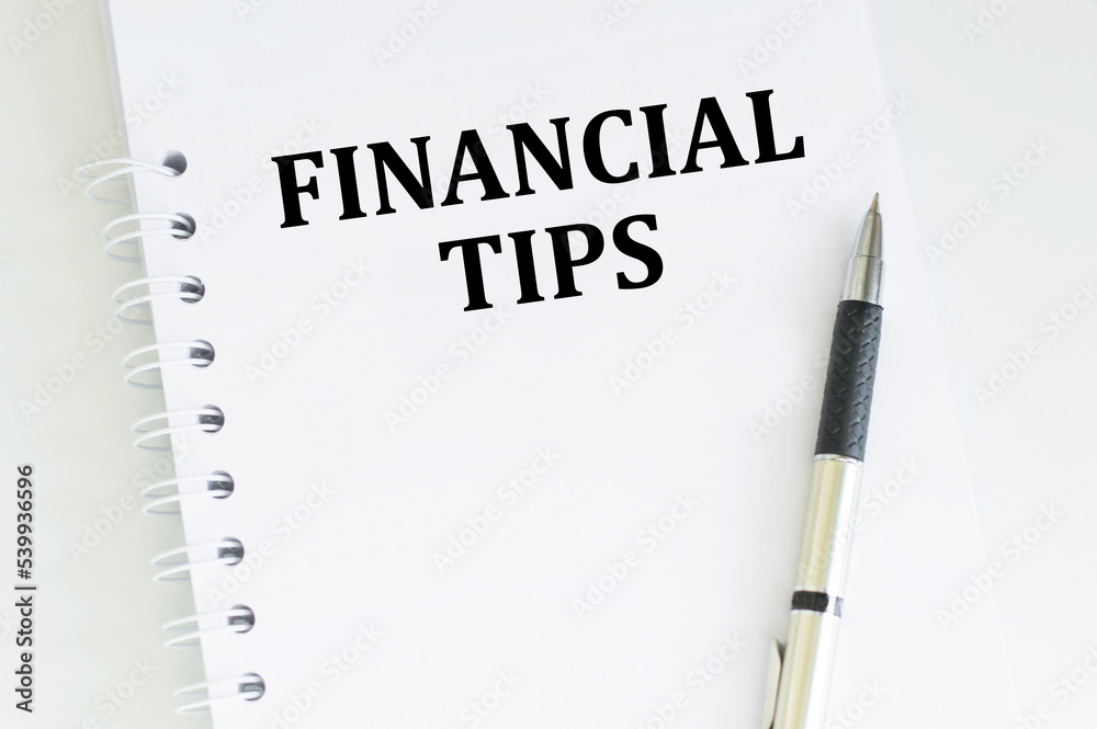 FINANCIAL TIPS . Text written on notepad the table FINANCIAL TIPS . Text written on notepad the table