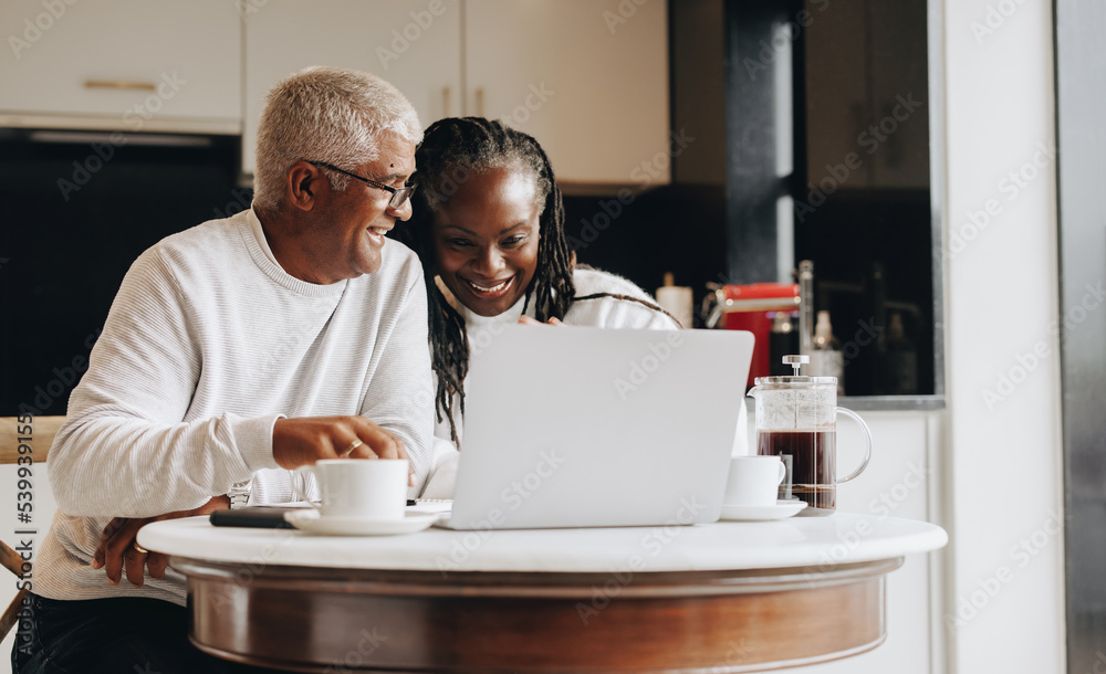 Happy senior couple having a video call at home Happy senior couple having a video call at home
