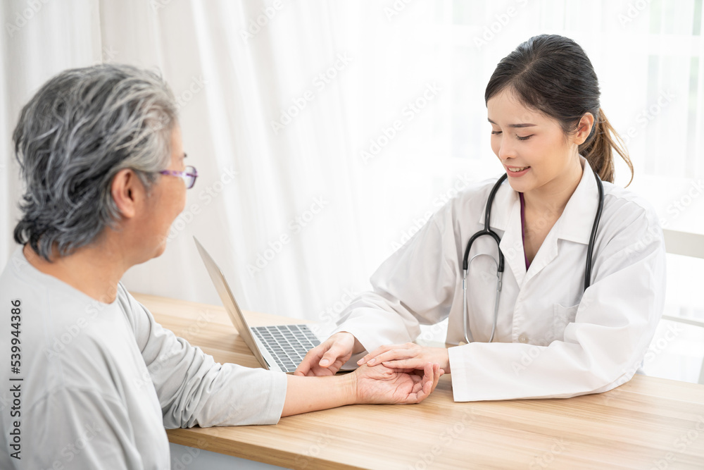 female doctor hanging stethoscope care senior woman and giving hope, holding her hand and smiling. Healthcare concept.