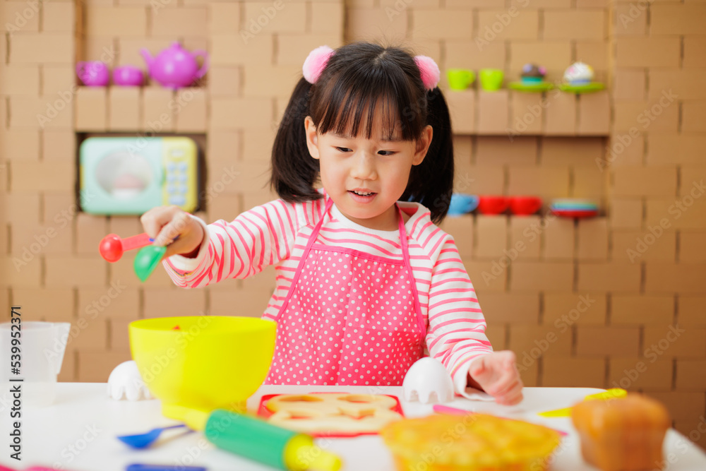 young girl pretend playing food preparing at home young girl pretend playing food preparing at home