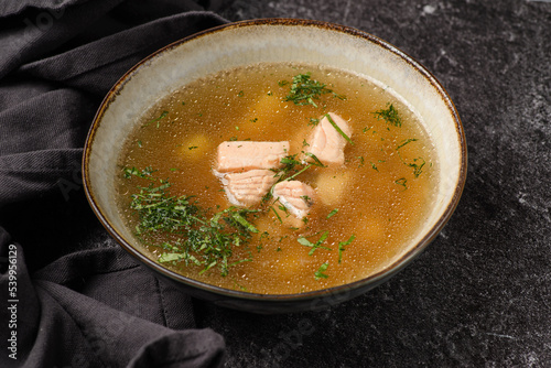 fish soup with salmon on a dark background photo