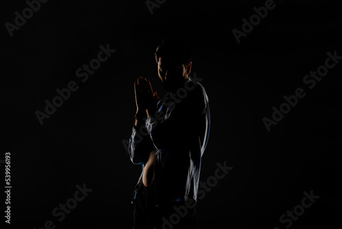 Male model posing in a light dimmed room © qunica.com