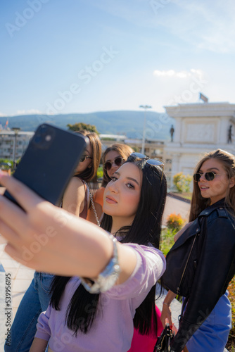 Close up of four girls taking selfies