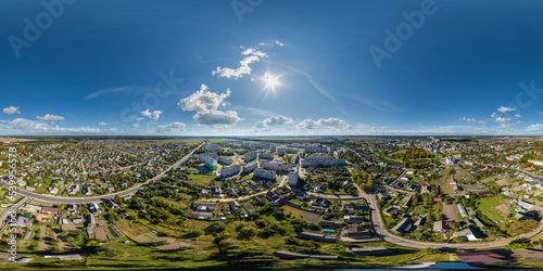 Fototapeta Naklejka Na Ścianę i Meble -  aerial full seamless spherical hdri 360 panorama view above road junction with traffic in small provincial town with private sector and high-rise apartment buildings in equirectangular projection.