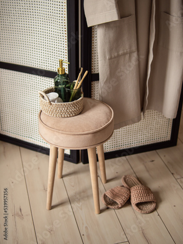 Round soft stool with wooden legs in bathroom. Natural. Interior of the shower room