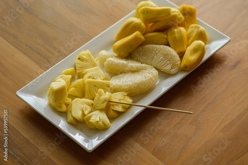 pineapple pomelo and jackfruit on a white plate photo