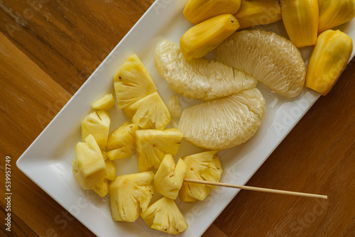 pineapple pomelo and jackfruit on a white plate photo