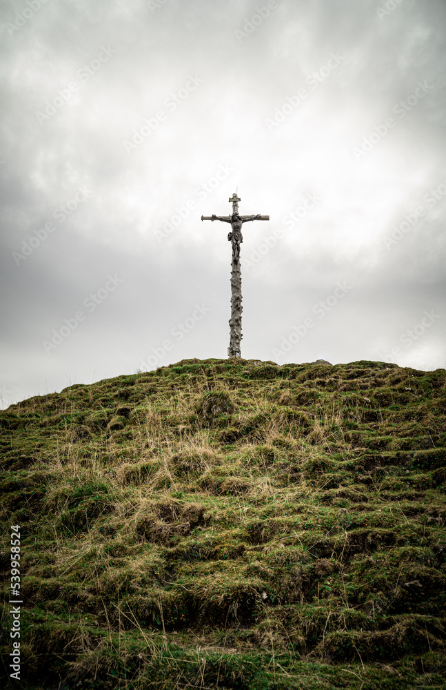 Cross on top of a mountain peak