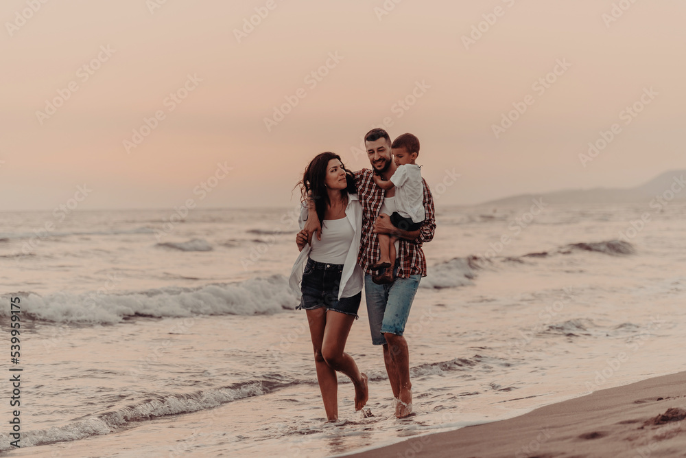 The family enjoys their vacation as they walk the sandy beach with their son. Selective focus 