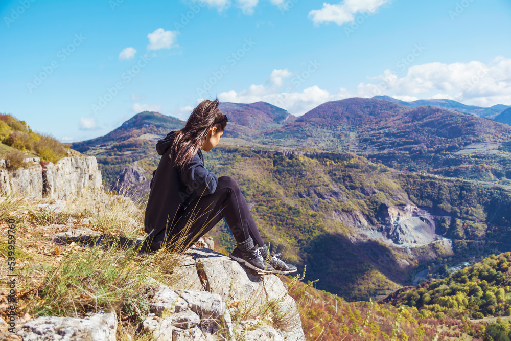 Naklejka premium Woman sitting high in the autumn mountain . Balkan mountains, ,Bulgaria