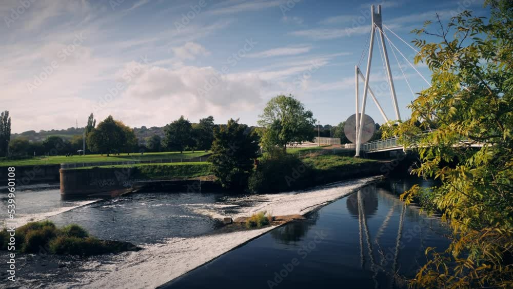 Water cascades over the weir at Miller's Bridge on the River Exe in ...