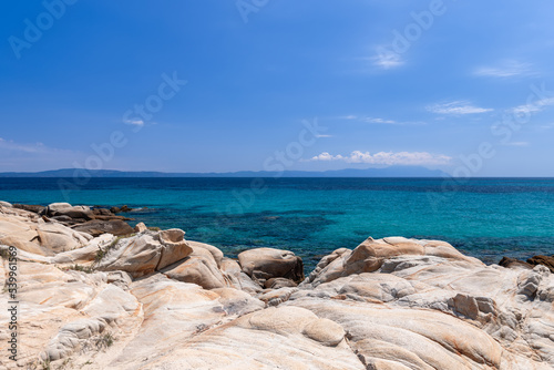 Unusual rounded rocks on costal line of Karidi beach, shallow warm water like in home bath. Vourvourou bay, Sithonia, Chalkidiki, Greece