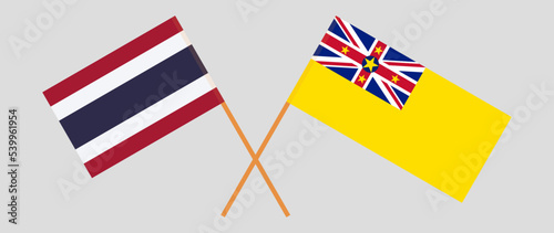 Crossed flags of Thailand and Niue. Official colors. Correct proportion