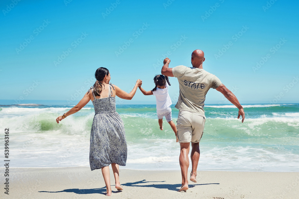 Beach, holding hands and family lifting child in the air, having fun, playing and enjoying the waves. Travel, summer and love on vacation with mom, dad and young girl together by the ocean on holiday