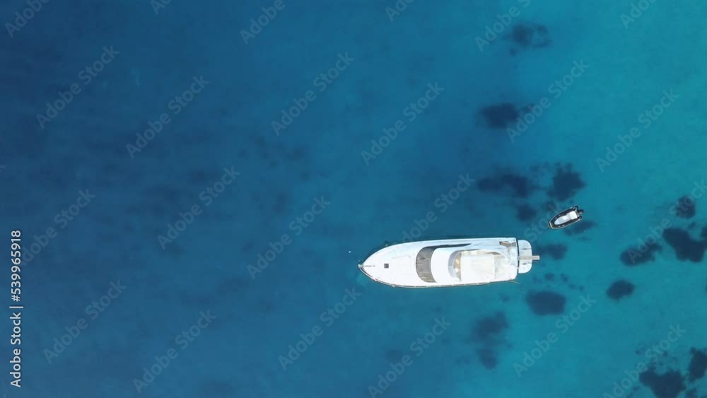 Aerial top view on sailboats and yacht and blue sea bottom, luxury summer tourism adventure, active vacantion in Mediterranean sea, Turkey, white boats on blue transparent water Aerial top view on sailboats and yacht and blue sea bottom, luxury summer tourism adventure, active vacantion in Mediterranean sea, Turkey, white boats on blue transparent water