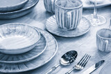 Empty blue gray plate as background.  Dining table setting