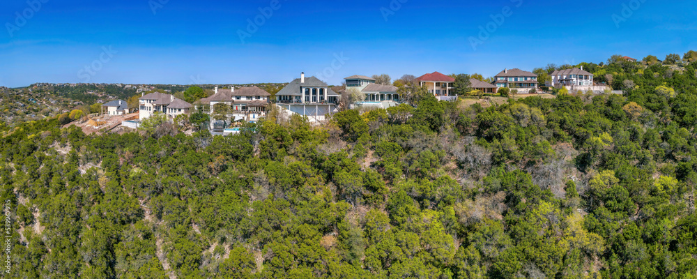 Austin, Texas- Mountain top residences against the blue sky