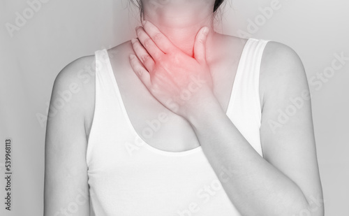 Photos Woman is touch neck with thirsty, flu, cold, pain, ache or itch