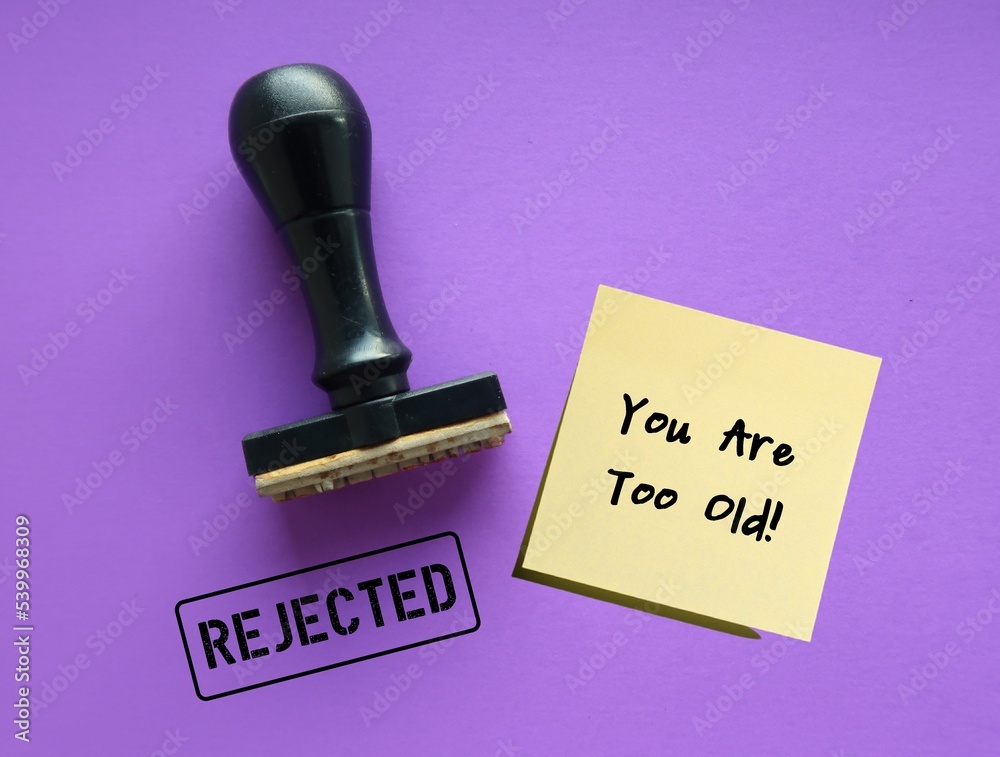 Rubber stamp on purple background with stamp text REJECTED, and note