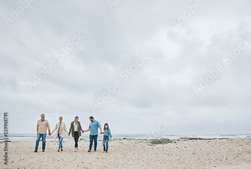 Big family, beach holiday and travel with child, parents and grandparents. Men, women and girl together for love, freedom and care on sea trip to relax, bond and enjoy a tropical winter vacation © Allistair F/peopleimages.com